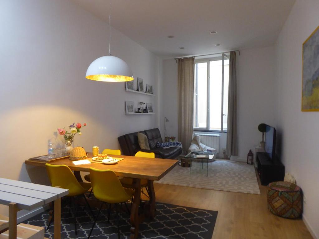 a living room with a table and yellow chairs at Covo Giulia in Genoa