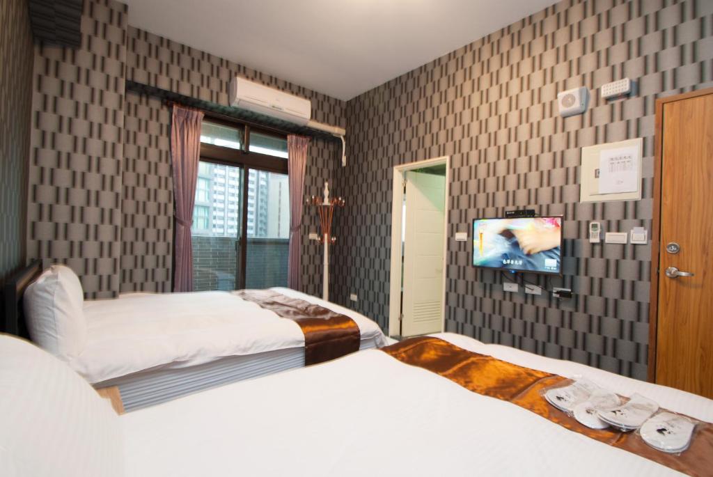 Postel nebo postele na pokoji v ubytování Yixiang Spring Travel