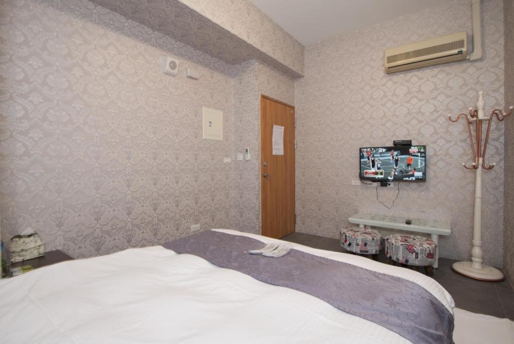 Postel nebo postele na pokoji v ubytování Yixiang Spring Travel