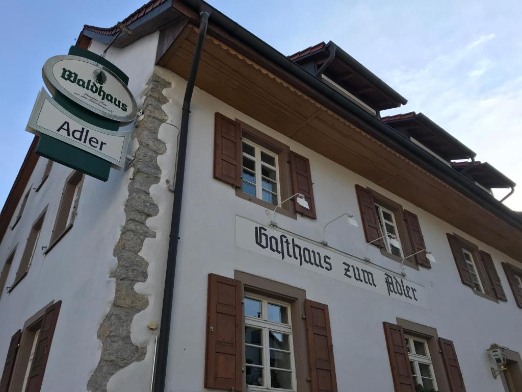 a building with a sign on the side of it at Gasthaus Adler in Nordschwaben