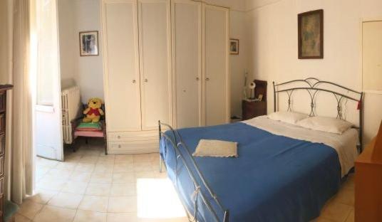 een slaapkamer met een blauw bed en een stoel bij Appartamento Via Ferdinando Galiani in Chieti