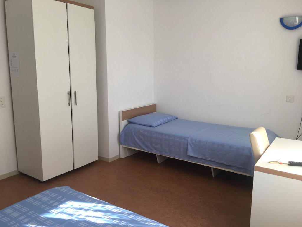 Postel nebo postele na pokoji v ubytování Hotel San Giobbe