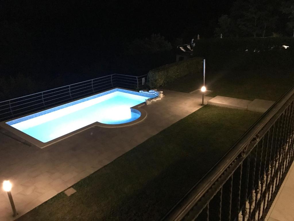 a swimming pool at night with lights at Villa Marion in Santalezi