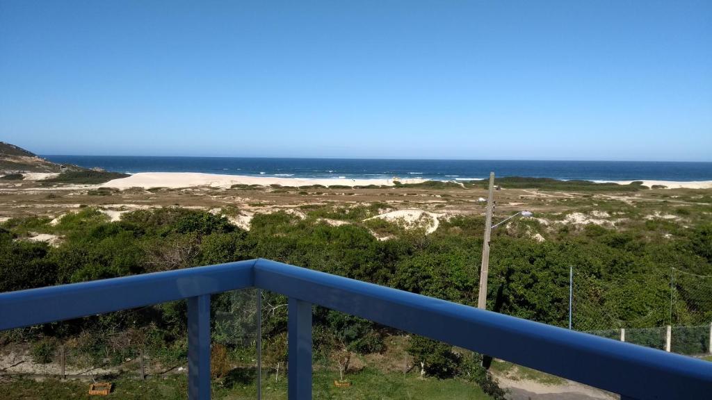 a view of the ocean from the balcony of a house at Casa da Marilú in Florianópolis