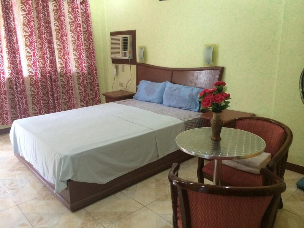 Postel nebo postele na pokoji v ubytování Sunrise Apartelle