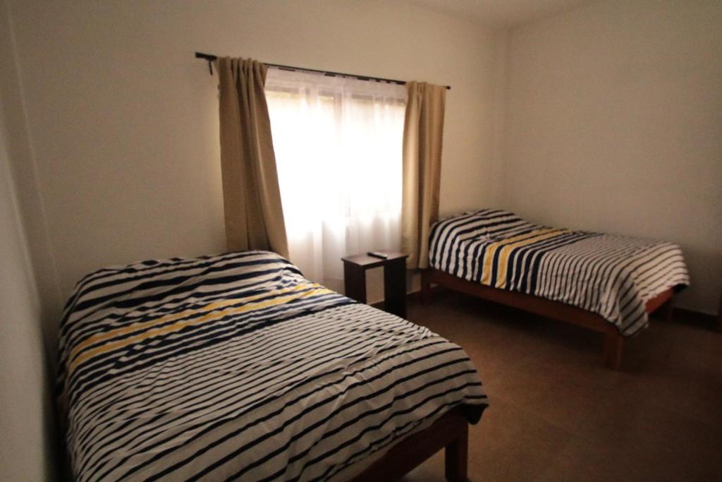 Postel nebo postele na pokoji v ubytování Posada Hacienda Real