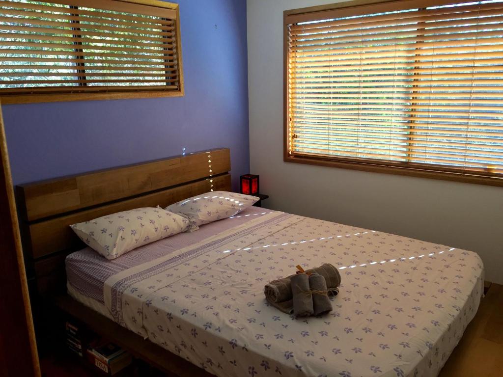 a stuffed animal sitting on a bed in a bedroom at Private Room In Everton Hills in Brisbane