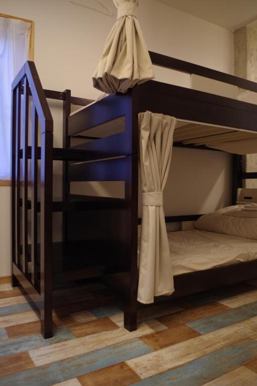 Postel nebo postele na pokoji v ubytování Cinnamon Guesthouse Dogo