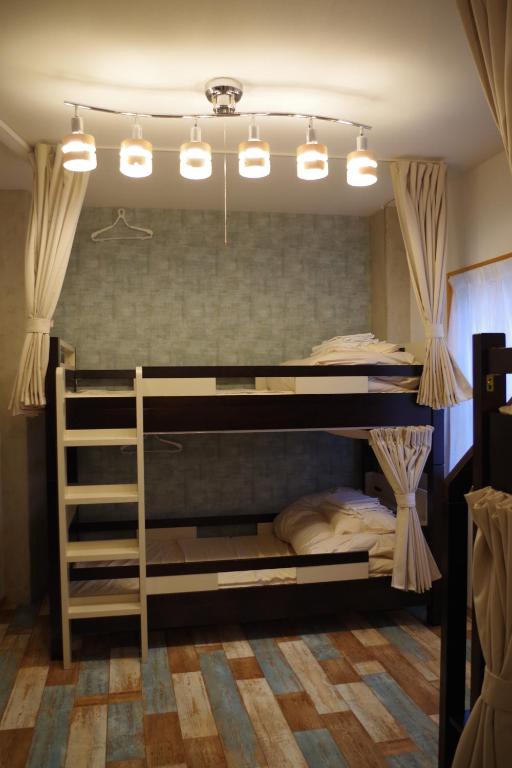 Postel nebo postele na pokoji v ubytování Cinnamon Guesthouse Dogo