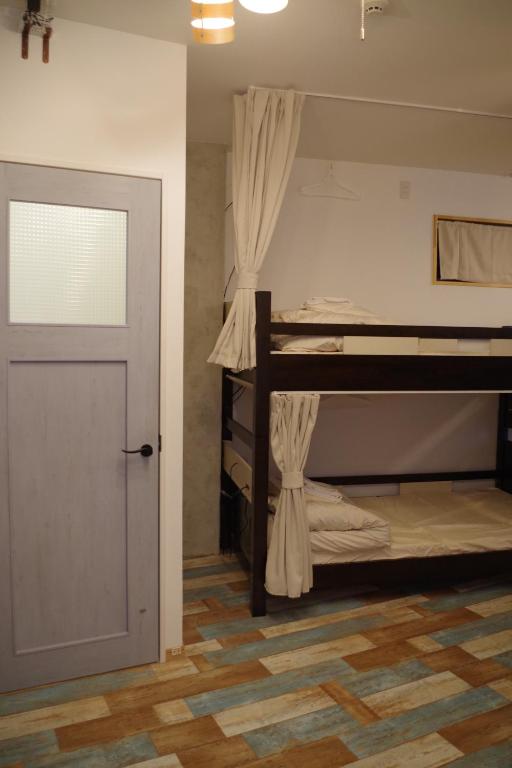 Postel nebo postele na pokoji v ubytování Cinnamon Guesthouse Dogo