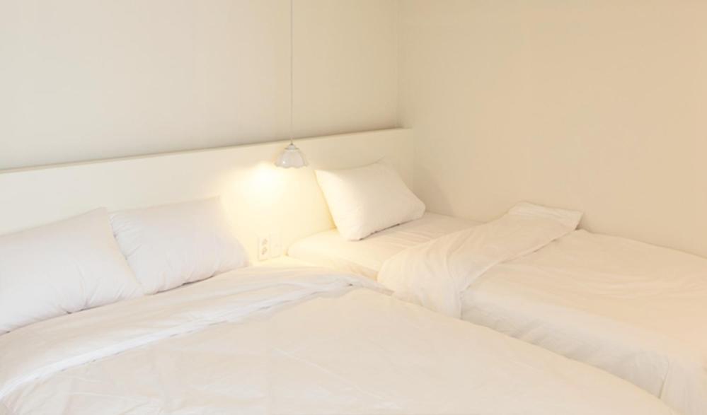 Postel nebo postele na pokoji v ubytování Hotel Kyungsung