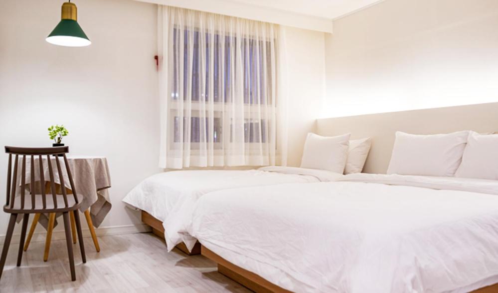 Postel nebo postele na pokoji v ubytování Hotel Kyungsung