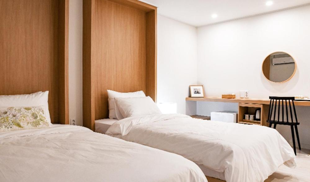 Postel nebo postele na pokoji v ubytování Hotel Kyungsung