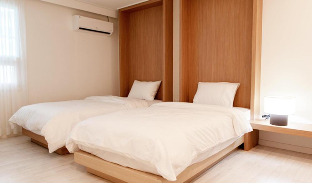 Postel nebo postele na pokoji v ubytování Hotel Kyungsung