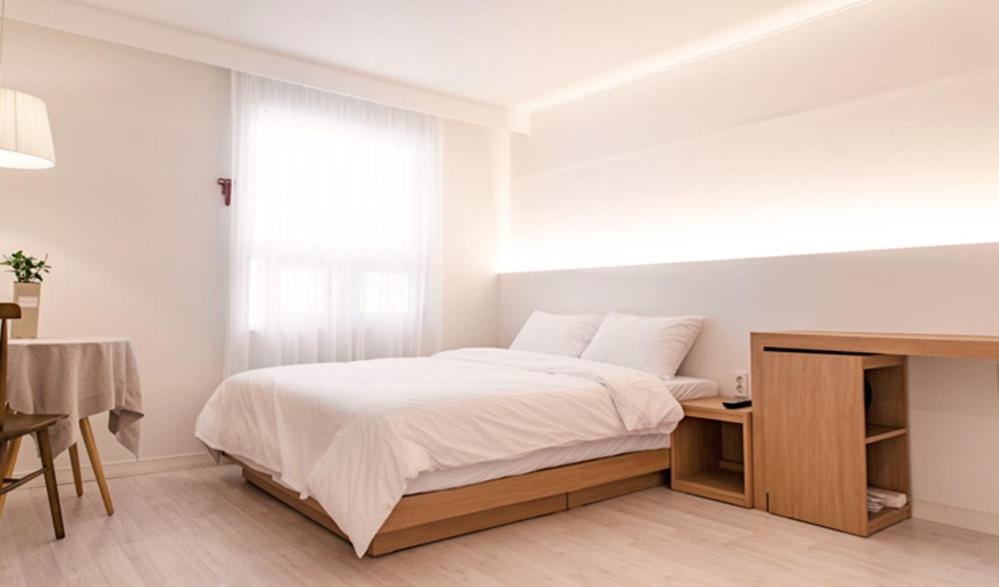 Postel nebo postele na pokoji v ubytování Hotel Kyungsung