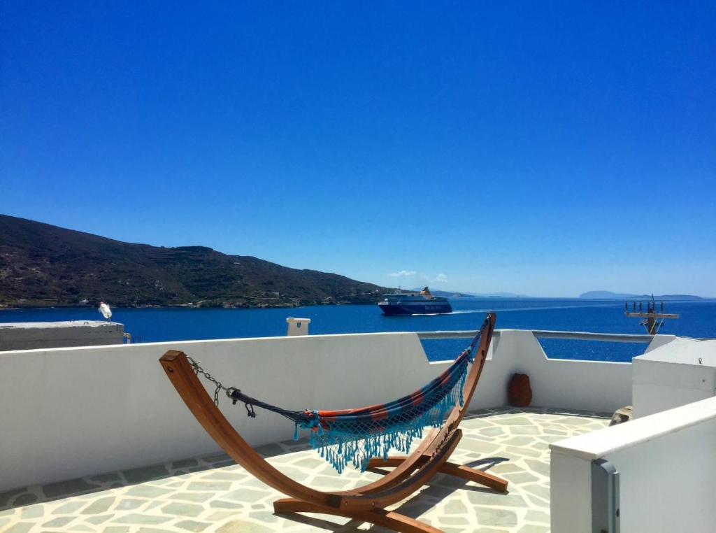 a hammock on the side of a building with the ocean at Greek Island Charming Studio in Amorgos