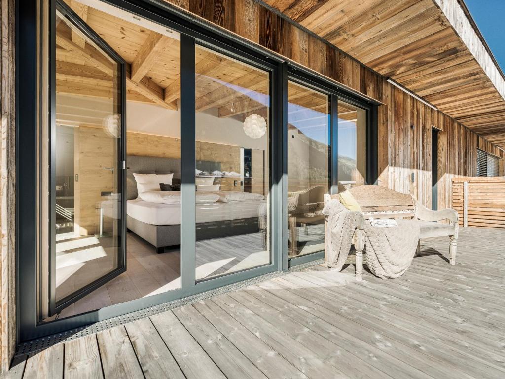 a room with sliding glass doors and a bedroom at Postresidenz in Mayrhofen