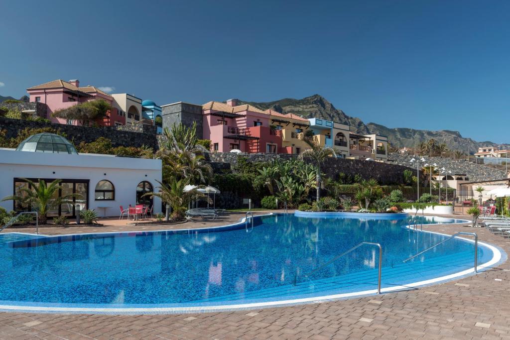 
a hotel room with a pool and a beach at Luz Del Mar in Los Silos
