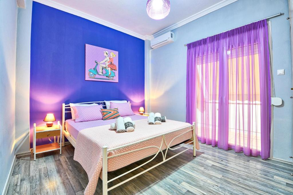 a bedroom with a bed and a purple wall at Lofos Apartment in Athens