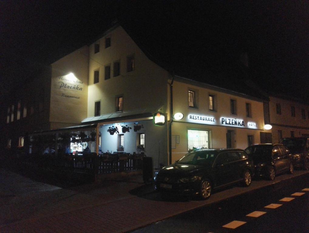 a car parked in front of a building at night at Horská chata Plzeňka Pernink in Pernink