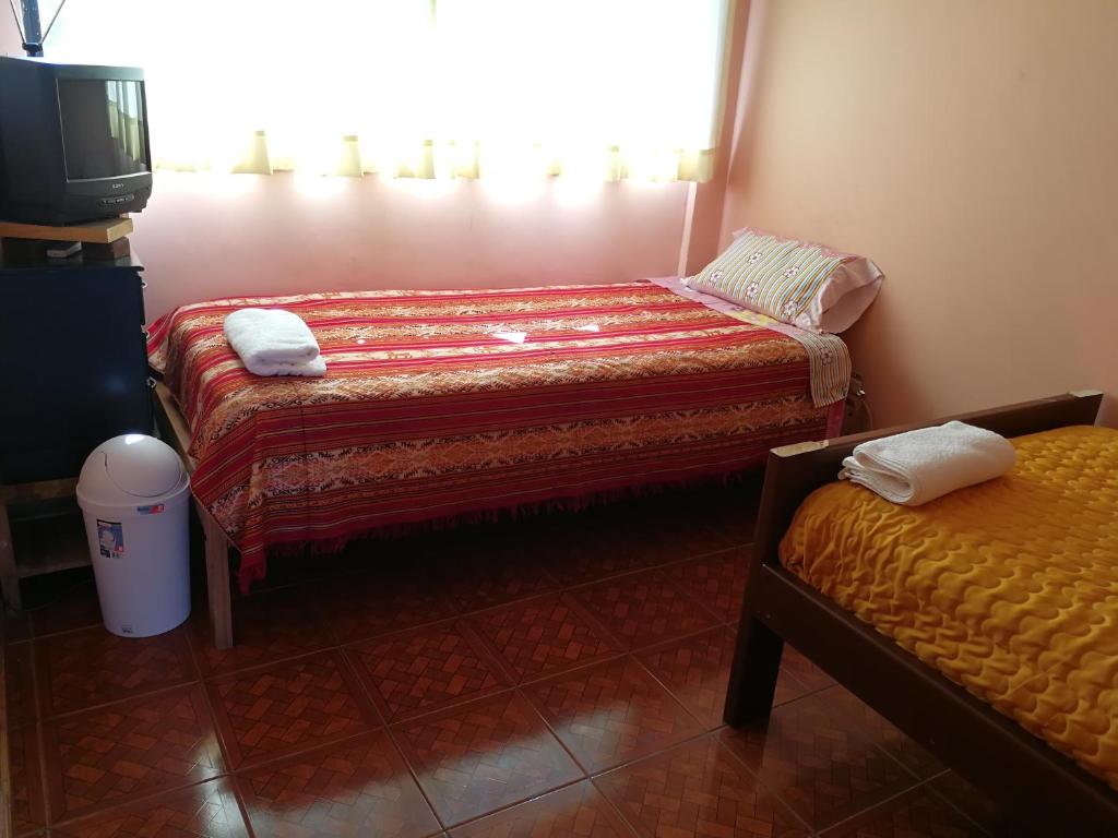 Postel nebo postele na pokoji v ubytování Chapelet Hostal