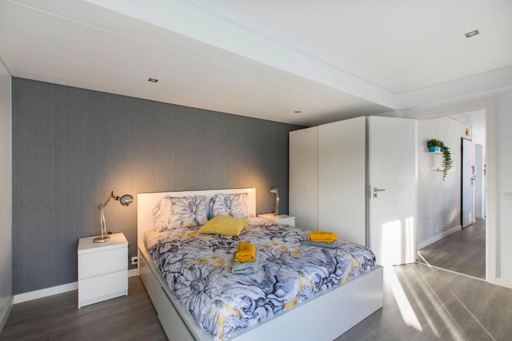 a bedroom with a large bed in a room at Maria Rita Faro Rooftop Apartment in Faro