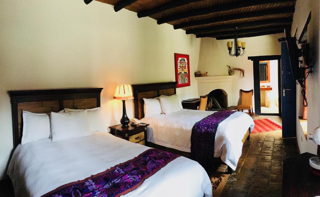 Postel nebo postele na pokoji v ubytování Guayaba Inn Boutique Hotel