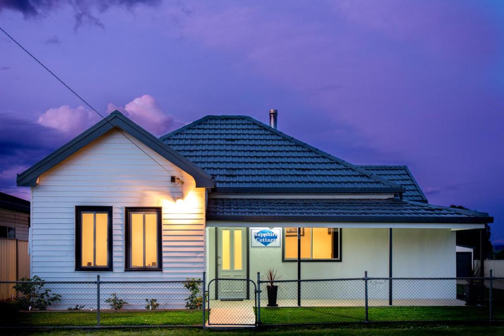 a house with its lights on in front of it at Sapphire Cottage in Glen Innes