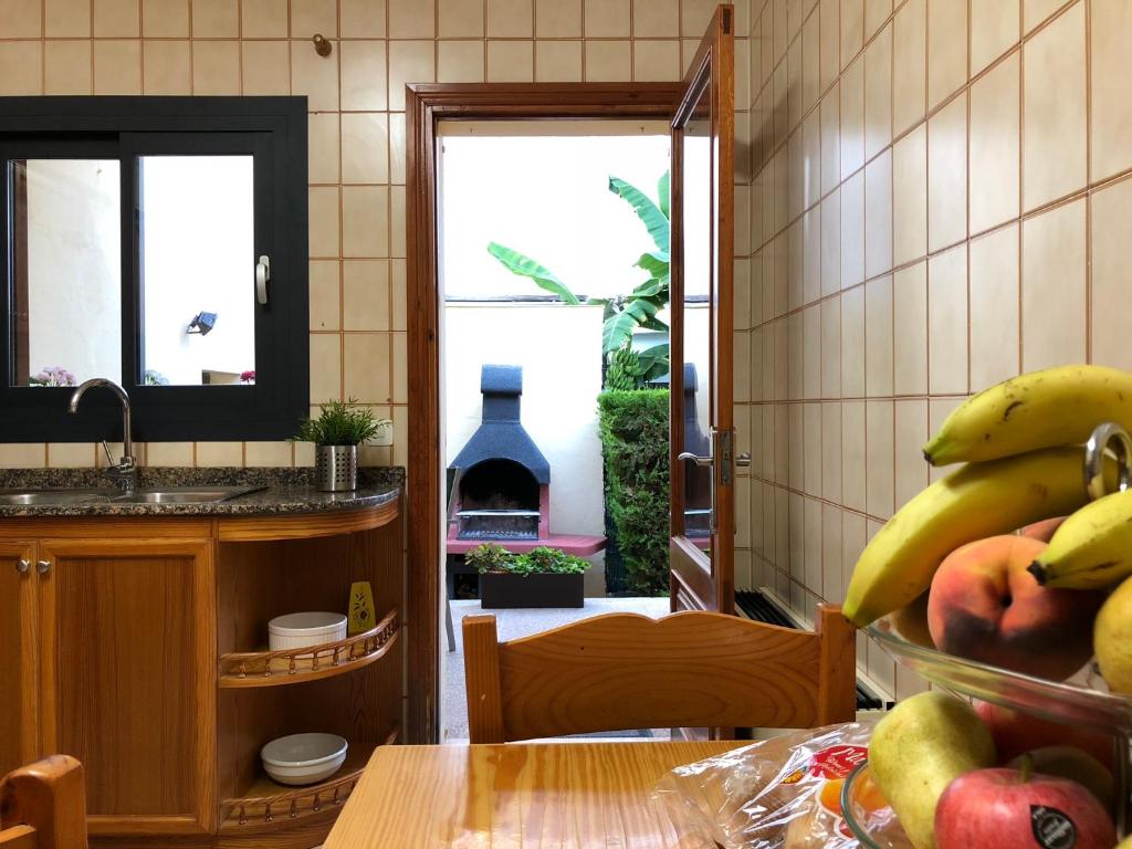 a kitchen with a table with a bunch of bananas at Casa Coromines in Alcudia