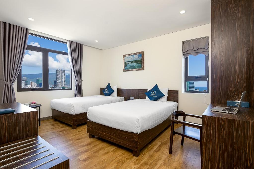 Postel nebo postele na pokoji v ubytování Sepon Blue Hotel