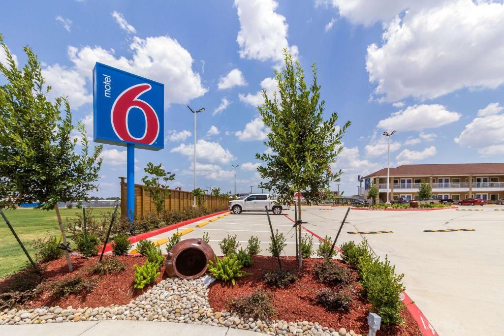 a gas station sign in a parking lot at Motel 6-Houston, TX - North in Houston