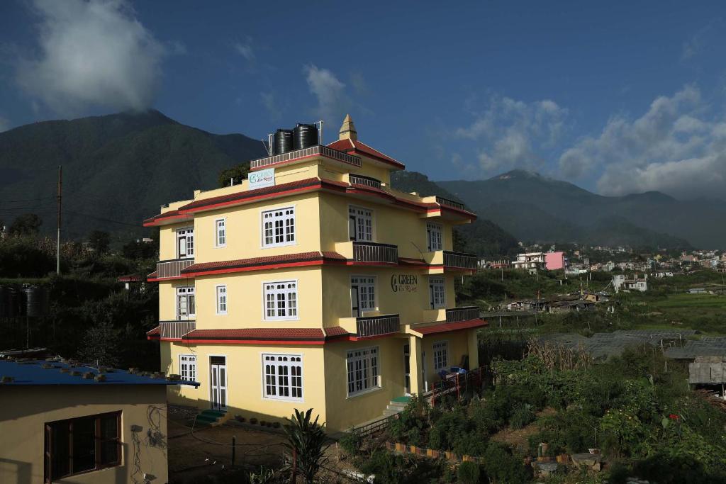 a large yellow building on top of a hill at Green Eco Resort in Kirtipur