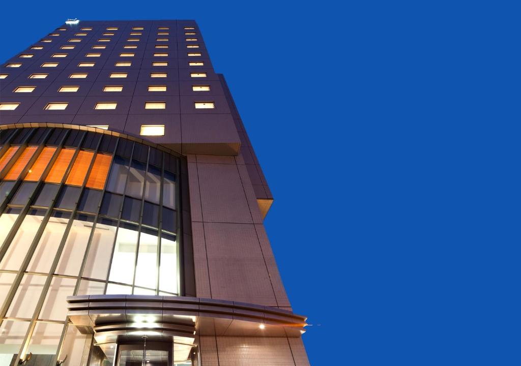 a tall black building with a blue sky in the background at Hiroshima Tokyu REI Hotel in Hiroshima