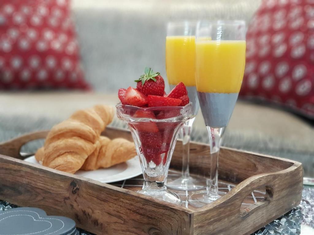 a tray with two glasses of fruit and croissants at Prosecco Palace in York