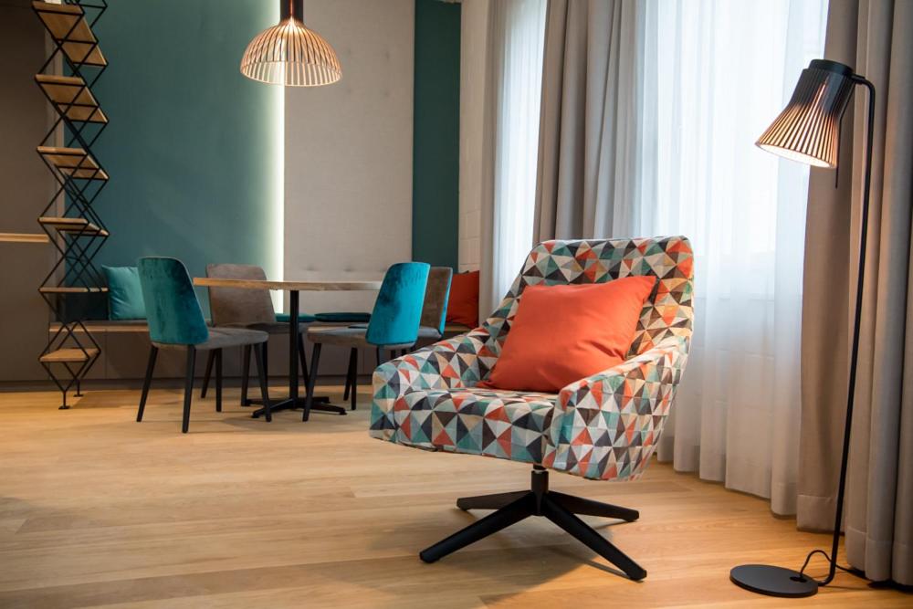 een woonkamer met een stoel en een tafel bij Aparthotel Luzern West in Alberswil