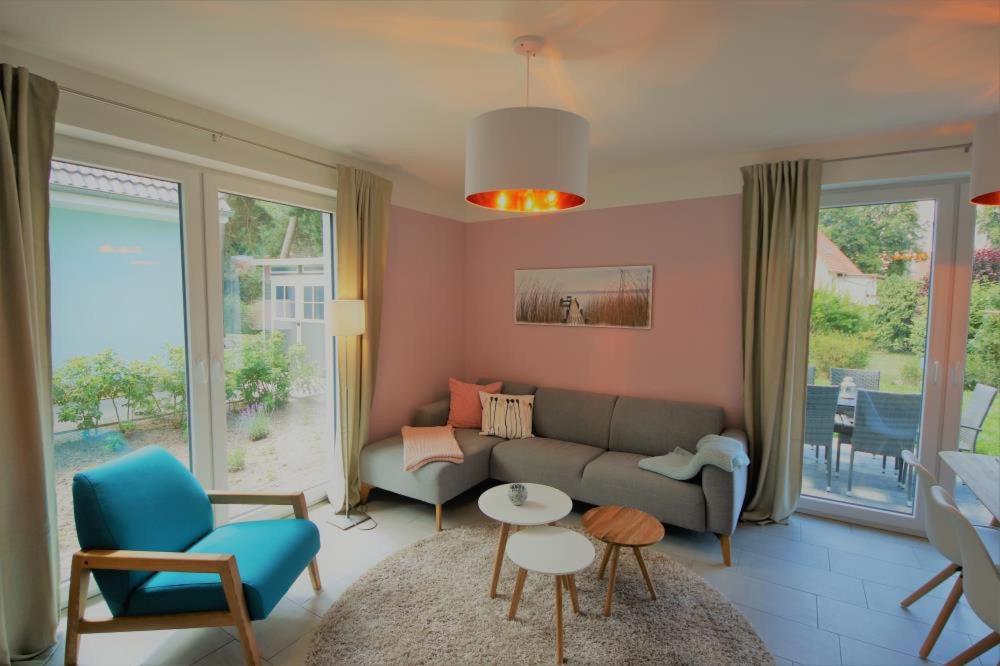 a living room with a couch and a table and chairs at K 100 EG - Ferienwohnung im Erdgeschoss mit großem Garten in Röbel