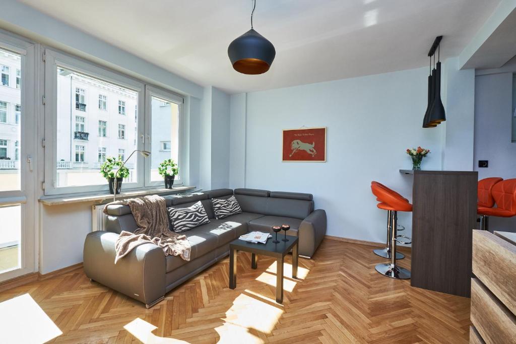 a living room with a couch and a table at Noctis Apartment Tamka in Warsaw