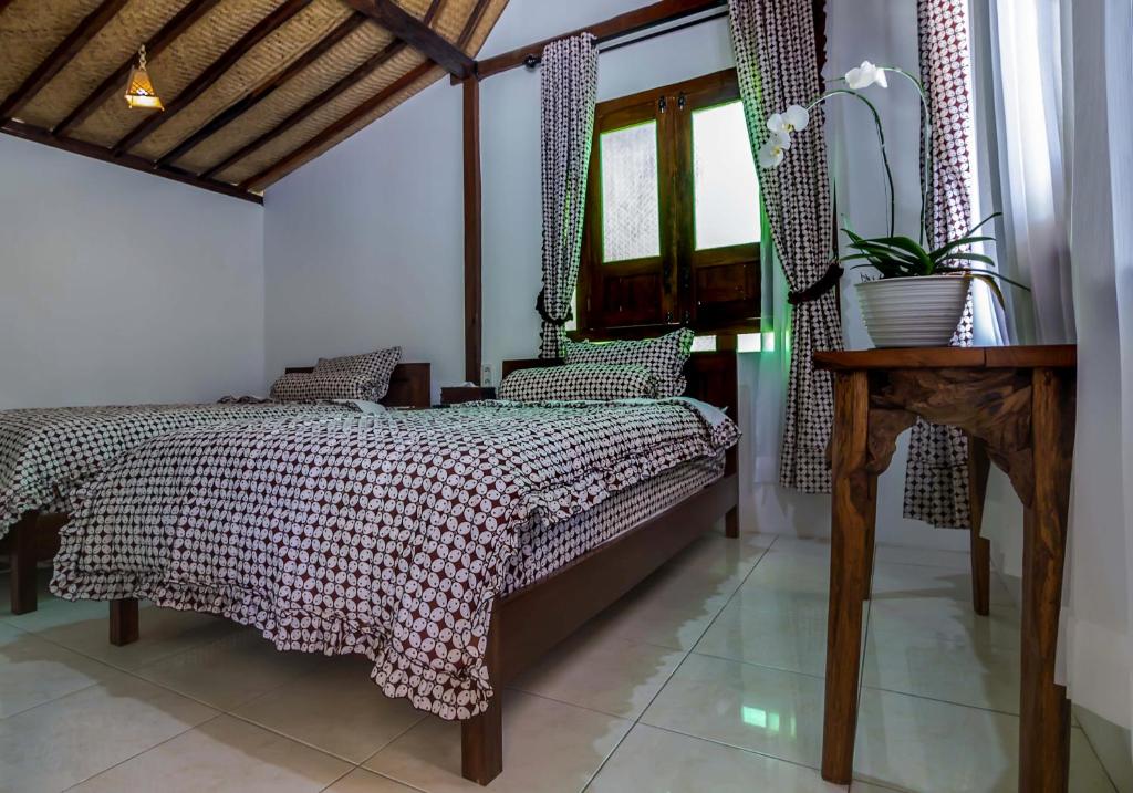 Letto o letti in una camera di The Omah Borobudur