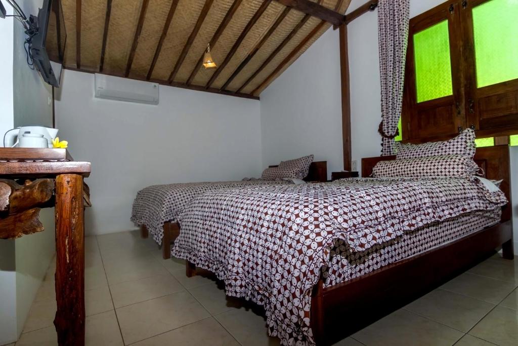 Letto o letti in una camera di The Omah Borobudur