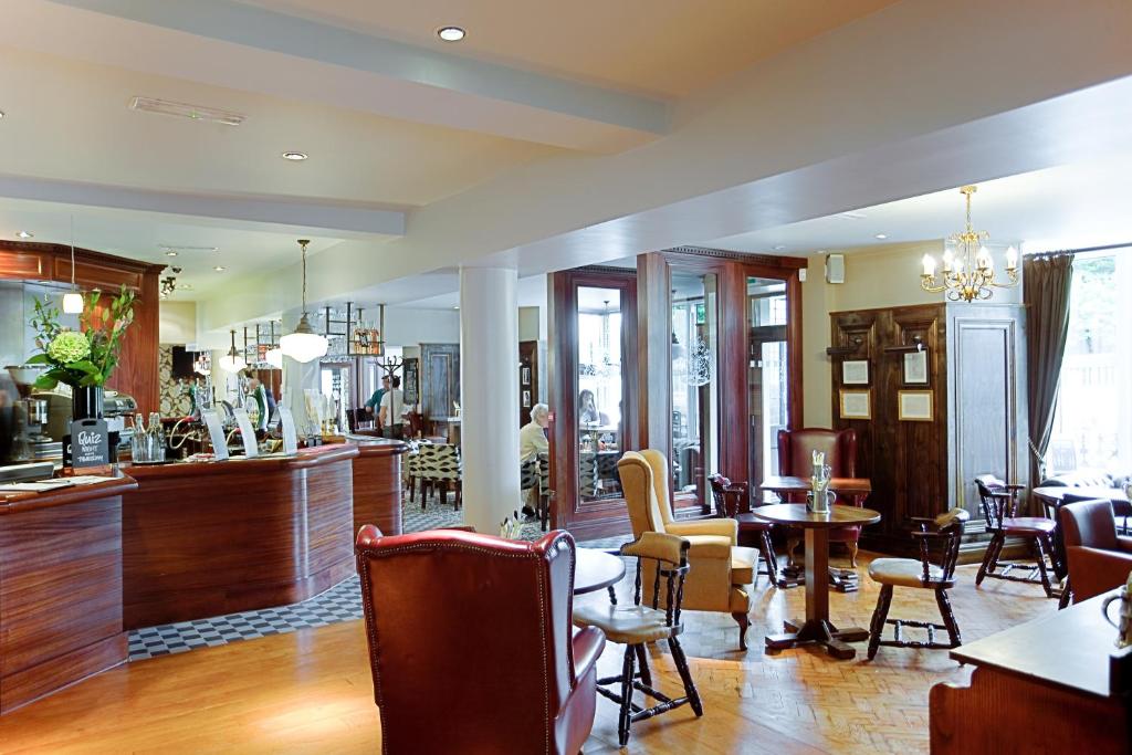 a kitchen filled with furniture and a large window at Anglesey Arms Hotel in Menai Bridge