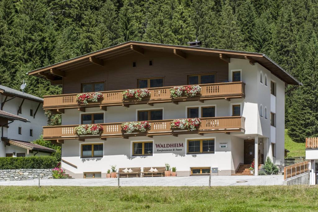 a large white building with a balcony at Haus Waldheim in Tux