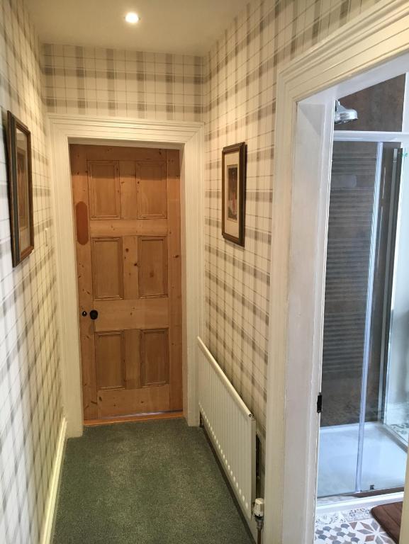a hallway with a door and a window at The Carrick in Portrush