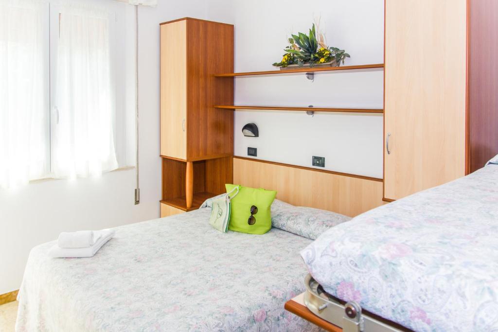 Postel nebo postele na pokoji v ubytování Hotel Trianon