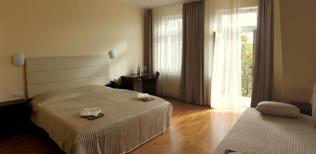 a hotel room with two beds and a window at Hotel Trevi in Prague