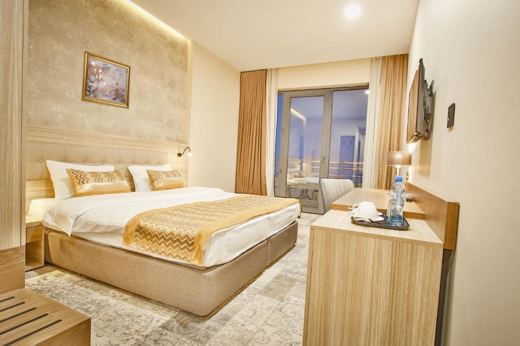 a hotel room with a bed and a television at Ameri Plaza Tbilisi in Tbilisi City
