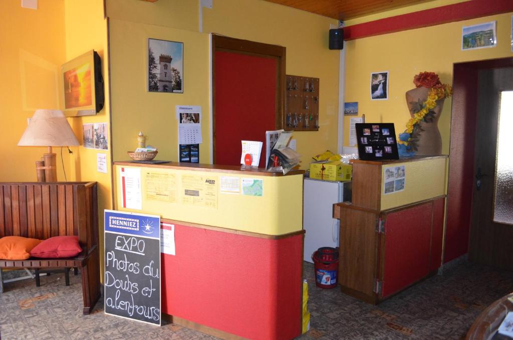 a kitchen with a colorful counter and a refrigerator at Chambres d'Hotes Le Passiflore in Les Brenets