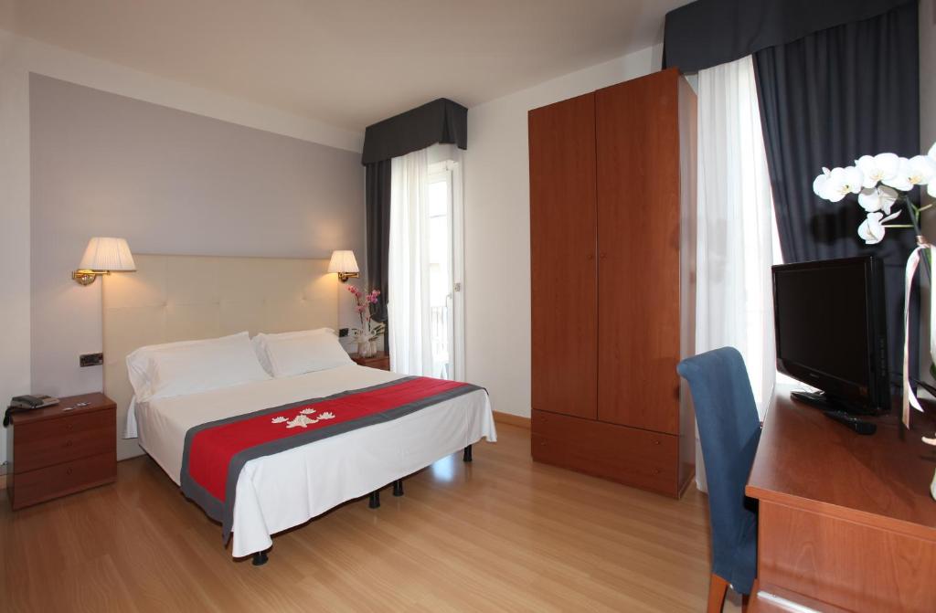 Postel nebo postele na pokoji v ubytování Hotel Santiago