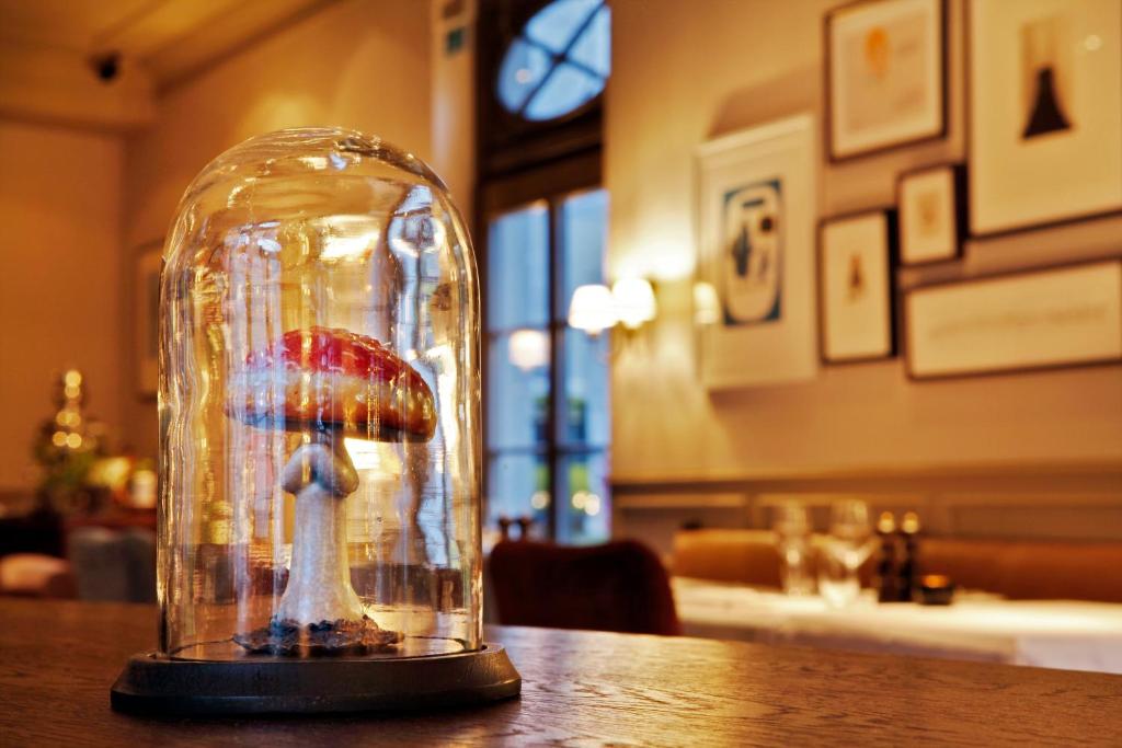 a glass cloche with a model of a woman holding an umbrella at Monbijou Hotel in Berlin