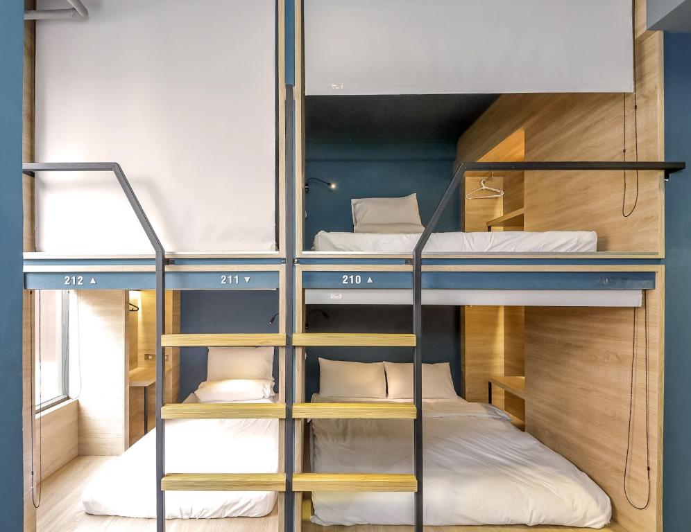 a bunk bed room with three bunk beds at DONGMEN 3 Hostel in Taipei