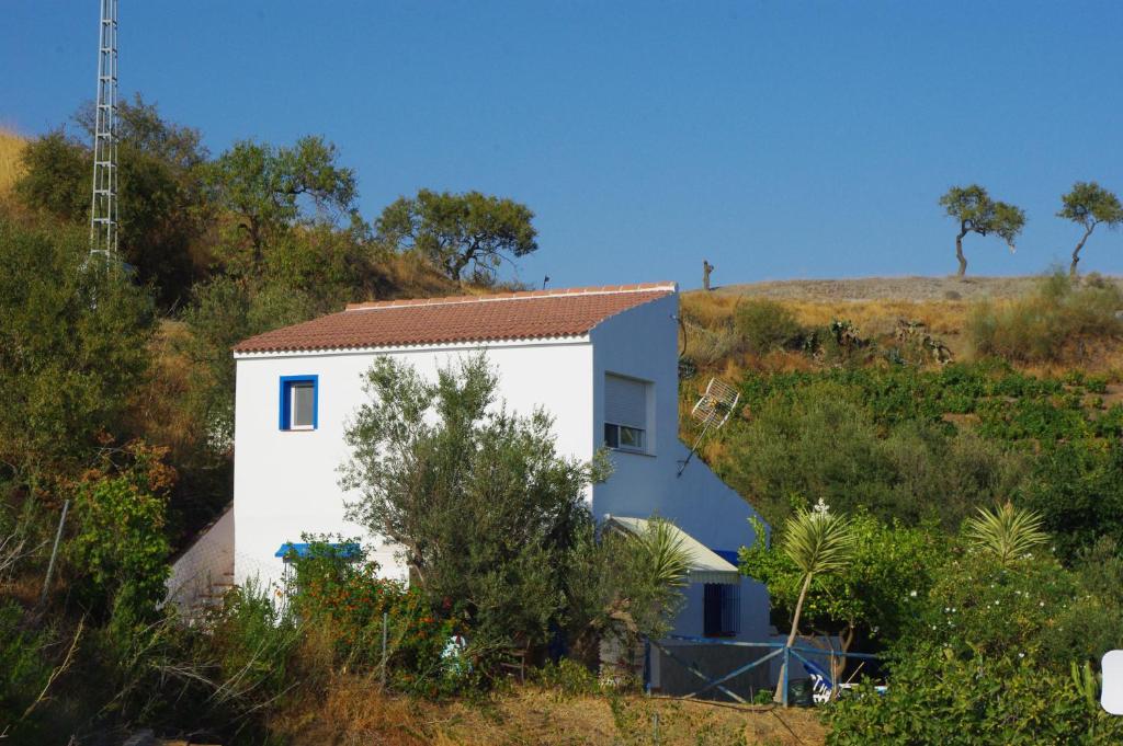 a white house on the side of a hill at Casa Feliz in Iznate